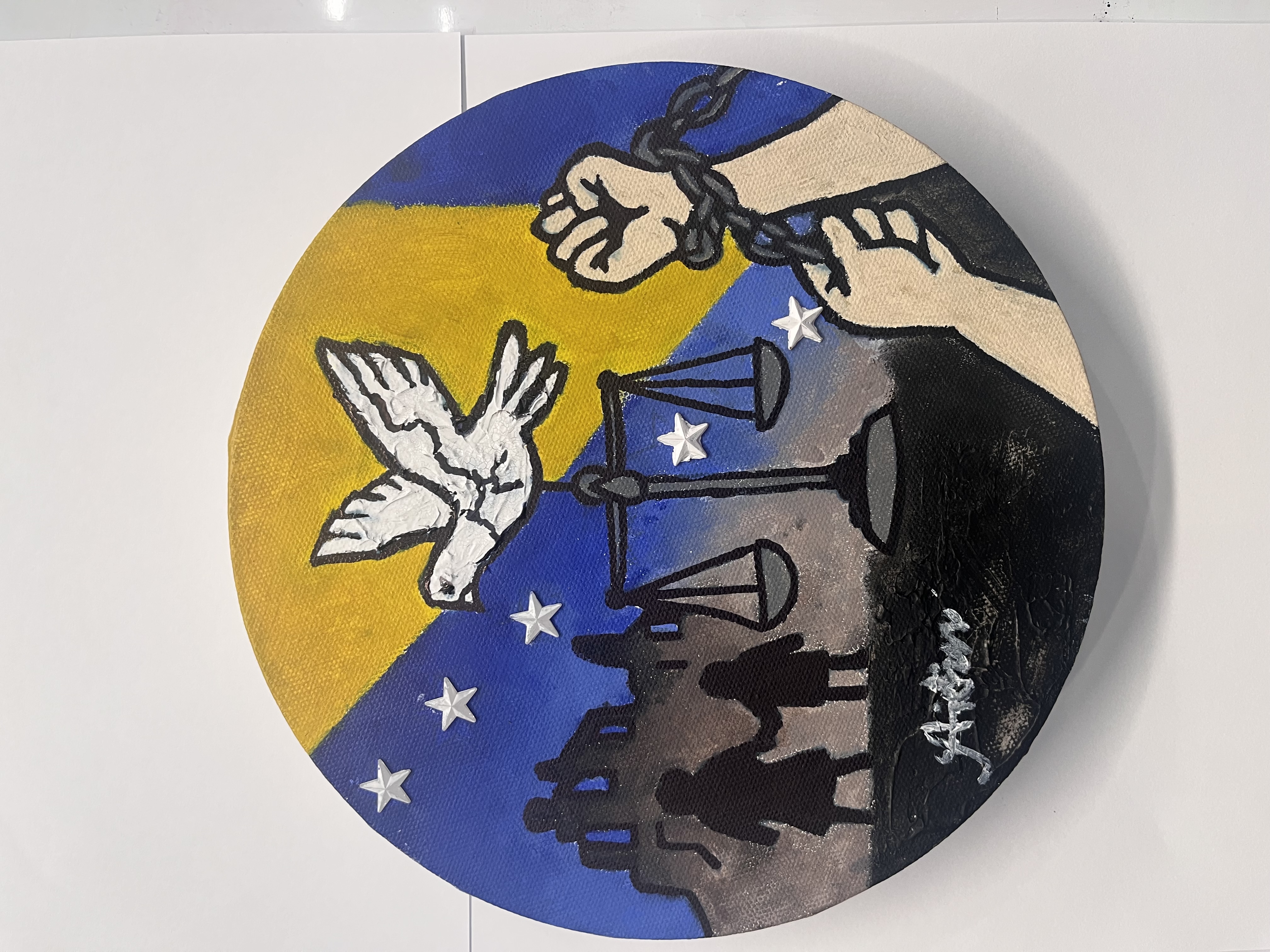 Round canvas painting featuring chained hands breaking free, a white dove of peace, scales of justice, and stars against a blue and gold Bosnian flag background